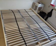 White wooden bed frame with slatted base