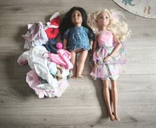 2 dolls with some baby doll clothes