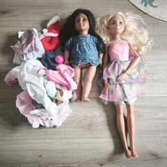 2 dolls with some baby doll clothes