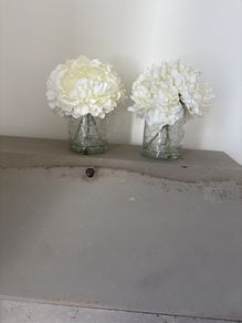 Pair of faux floral decorations with glass vases