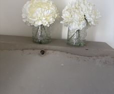 Pair of faux floral decorations with glass vases