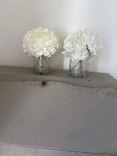 Pair of faux floral decorations with glass vases