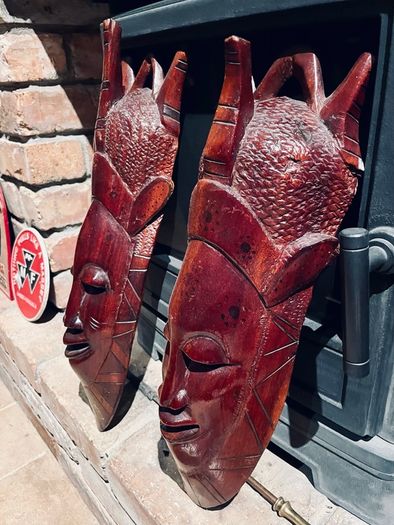 Two carved tribal masks