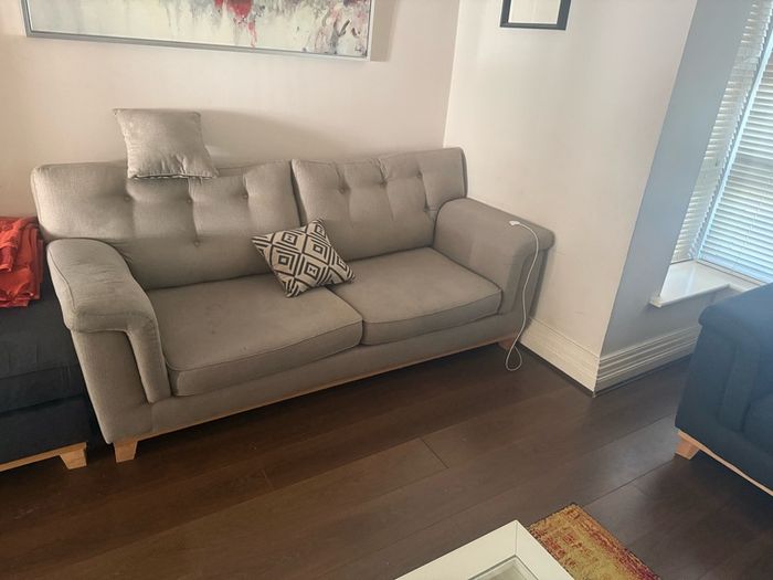 Grey 2-seater sofa with navy ottoman