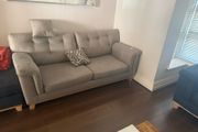 Grey 2-seater sofa with navy ottoman