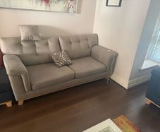 Grey 2-seater sofa with navy ottoman
