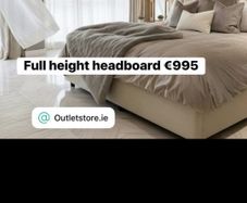 Full wall height headboard in cream boucle fabric