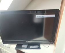 42 inch Philips tv with stand, sky puck and sky remote.