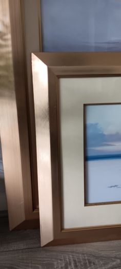 Two gold frame pictures with boats