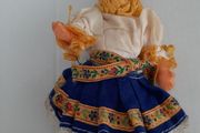 Small vintage rubber doll in costume