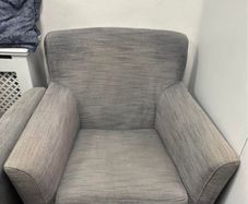 Two grey fabric armchairs