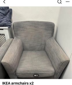 Two grey fabric armchairs