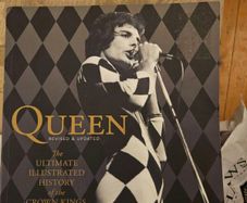 Queen. The Ultimate Illustrated History Of The Crown Kings Of Rock. By Phil Sutcliffe. First Edition Large Volume Paperback In Good Condition.  See Photos For Same.