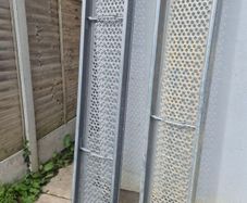 Two galvanised steel scaffolding planks