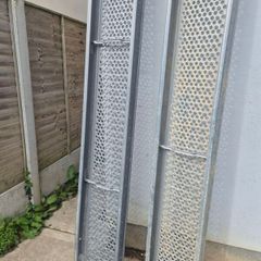 Two galvanised steel scaffolding planks
