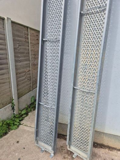Two galvanised steel scaffolding planks