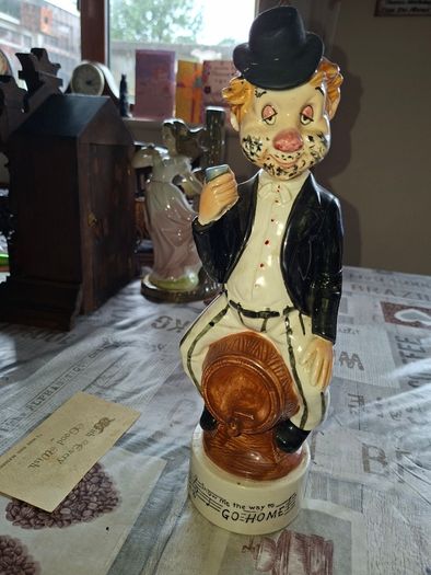 1950s to 70s Working Musical Decanter Hobo Clown Sitting on a Barrel. The base plays the tune Show Me the Way to Go Home, reminded me of the song from Jaws