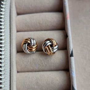 Beautiful silver and rose gold-tone knot stud earrings.
