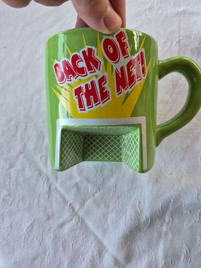 A novelty flick football interactive coffee mug