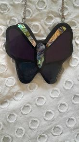 A striking vintage butterfly pendant necklace by Accessorize, featuring iridescent mother of pearl / abalone shell set within black, purple and deep blue resin.