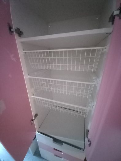 Pink and white children's wardrobe with internal wire baskets