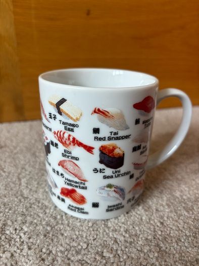 A Mug Featuring Different Types of Sushi