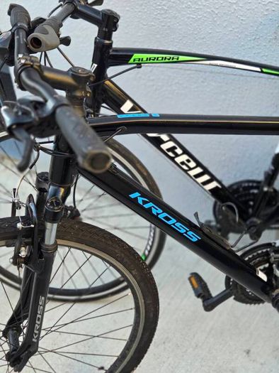 Two bikes one mountain one is a type of racing mountain bike