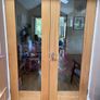 Solid wood internal double doors with clear glass panels Image 2