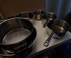 Saucepans, lids... plus knife sharpener