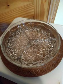 Nut dish in the holder is plastic have wood finished.