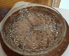 Nut dish in the holder is plastic have wood finished.