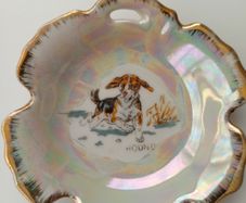 Small porcelain lustre trinket plate depicting Hound with sign Foreign at the back  D 9.5cm