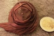 leather face brooch