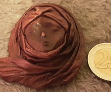 leather face brooch
