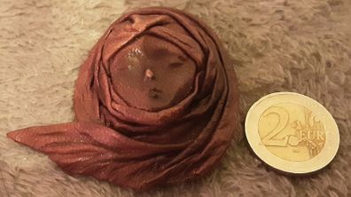 leather face brooch