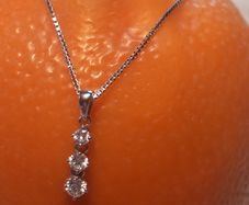 Three diamond pendant and 9ct white gold chain, D18 free reg post