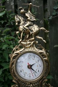 Vintage Ornate gold / brass Mantle Clock with Jousting Knight on Horse. Portugal Quartz.