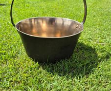 19th-century antique solid brass preserving pan with a hand-forged iron swing handle.