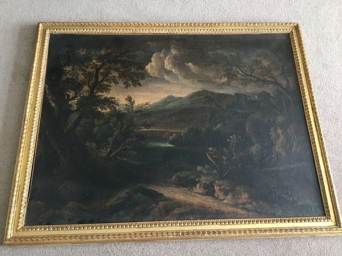 Circle of Francesco Zuccarelli  mountainous landscape by a lake with a fortress