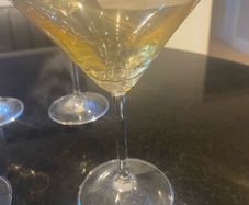 Set of four amber and plain glass martini or cocktail glasses