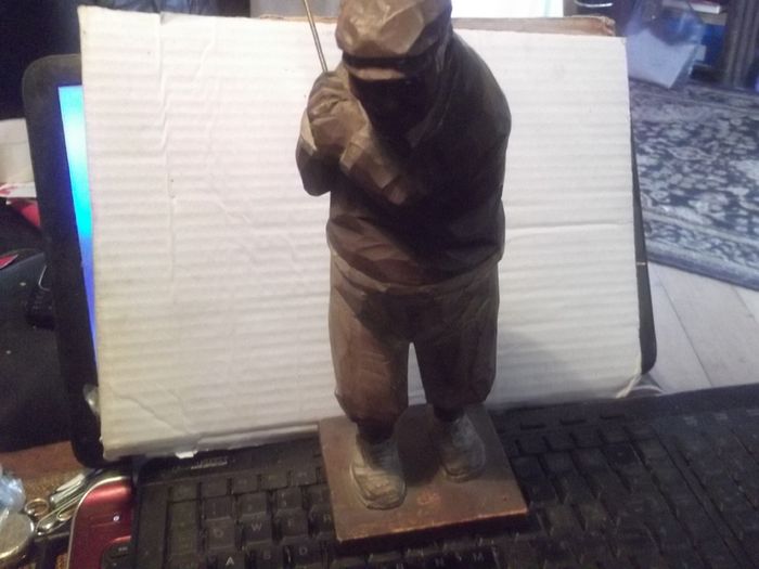 a antique carved wood golfer