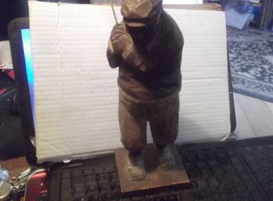 a antique carved wood golfer
