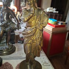 Antique Sculpture a gilt-bronze cast-metal Spanish Conquistador. On his torso is a Cross Pattee, a historical motif commonly associated with Christian military orders and medieval heraldry