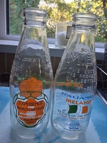 Two Italia 90 milk bottles