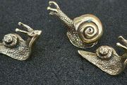 3 brass snails.