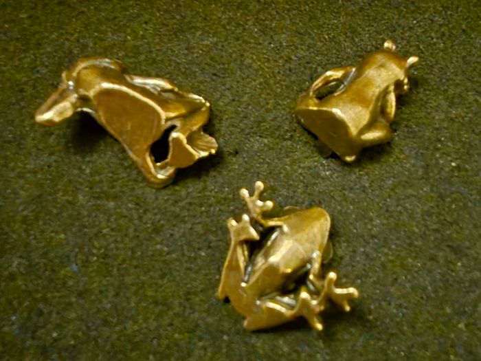 3 brass frogs.