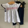 2 piece baby outfit navy leggings white top with neon orange thread detail & navy fringing on capped sleeves Image 3