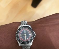 TAG HEUER WRIST WATCH, black dial with date, stainless steel bracelet strap, case ca. 34 mm