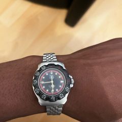 TAG HEUER WRIST WATCH, black dial with date, stainless steel bracelet strap, case ca. 34 mm