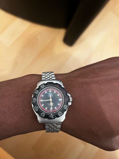 TAG HEUER WRIST WATCH, black dial with date, stainless steel bracelet strap, case ca. 34 mm